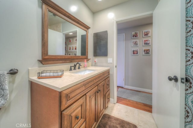 bathroom with vanity, baseboards, and visible vents