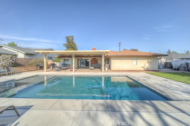 view of swimming pool with a patio area, outdoor lounge area, a fenced in pool, and fence