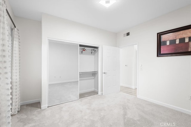 unfurnished bedroom featuring carpet flooring, baseboards, and visible vents