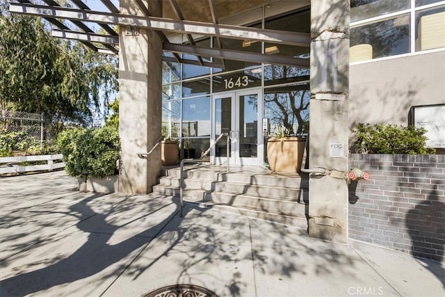 view of patio / terrace featuring fence and french doors