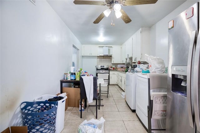 kitchen featuring a ceiling fan, appliances with stainless steel finishes, white cabinetry, separate washer and dryer, and light tile patterned flooring