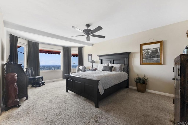 carpeted bedroom featuring baseboards and ceiling fan