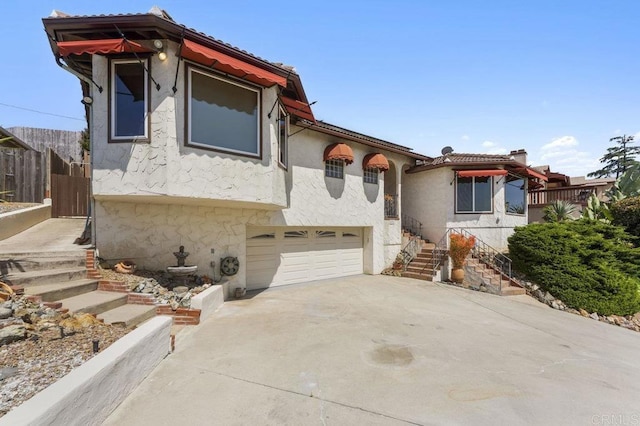 4331 Summit Dr, La Mesa, CA 91941 - mediterranean / spanish house with a garage, stucco siding, driveway, stairway, and stone siding