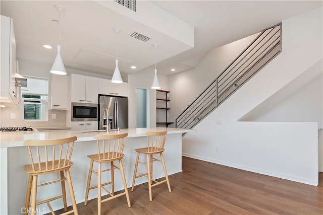 kitchen with visible vents, a breakfast bar area, and stainless steel appliances