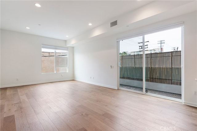 spare room featuring recessed lighting, baseboards, visible vents, and wood finished floors