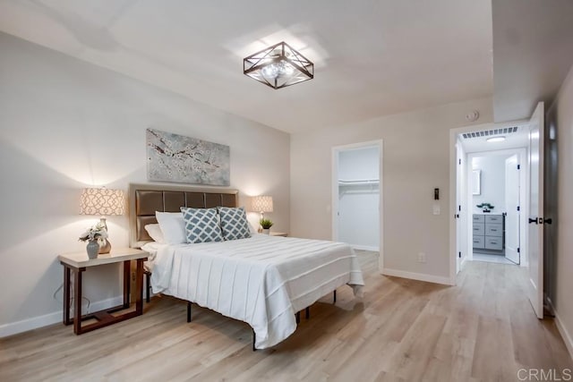 bedroom featuring baseboards, visible vents, and light wood-style flooring