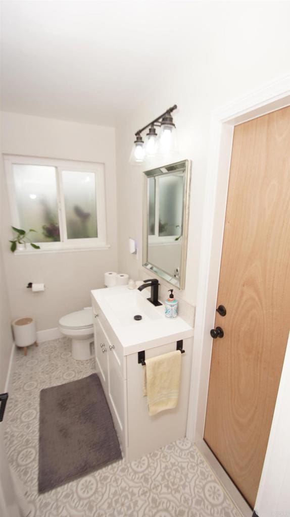 8394 Blue Lake Dr, San Diego, CA 92119 - half bathroom featuring vanity, baseboards, tile patterned floors, and toilet