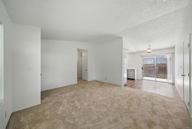 unfurnished living room featuring carpet and a textured ceiling