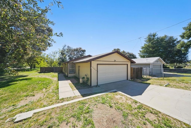 single story home with fence, concrete driveway, and a front yard