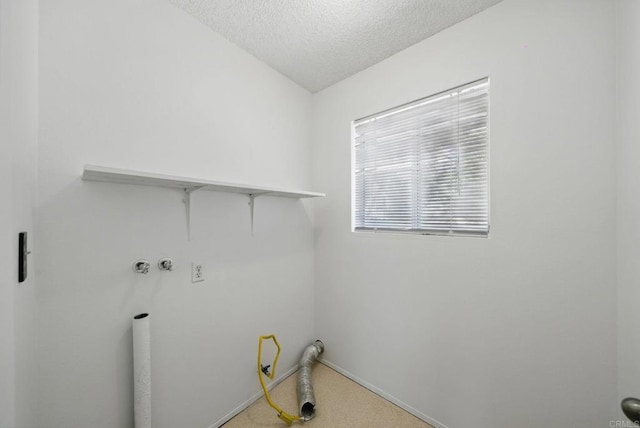 washroom with laundry area, carpet floors, baseboards, hookup for a washing machine, and a textured ceiling