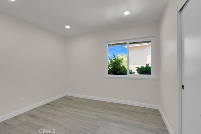 unfurnished room featuring recessed lighting, baseboards, and light wood-style floors