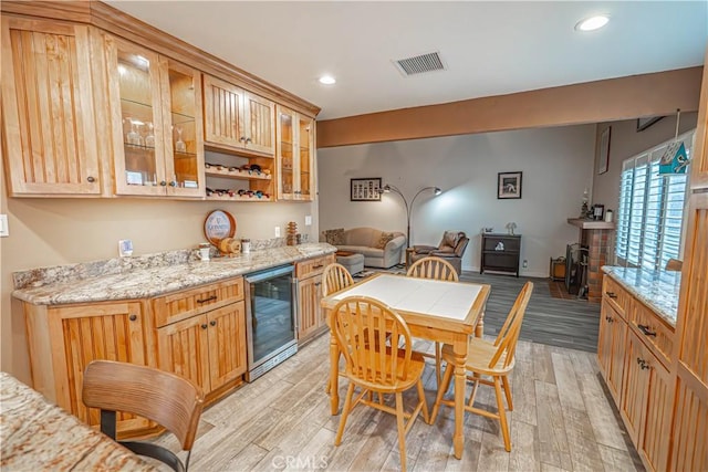 2650 Belburn Pl, Simi Valley, CA 93065 - kitchen with beverage cooler, light wood finished floors, glass insert cabinets, open floor plan, and recessed lighting