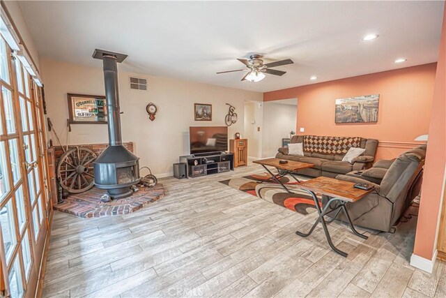 2650 Belburn Pl, Simi Valley, CA 93065 - living room featuring a wood stove, ceiling fan, light wood-type flooring, recessed lighting, and french doors