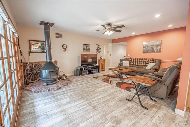 2650 Belburn Pl, Simi Valley, CA 93065 - living room with a wood stove, a ceiling fan, light wood finished floors, recessed lighting, and french doors