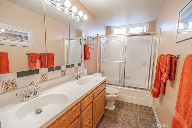 2650 Belburn Pl, Simi Valley, CA 93065 - bathroom featuring stone finish flooring, combined bath / shower with glass door, toilet, and double vanity