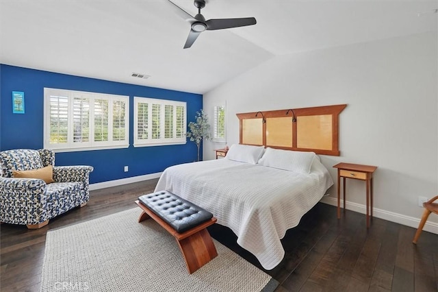 bedroom with ceiling fan, visible vents, vaulted ceiling, hardwood / wood-style flooring, and baseboards