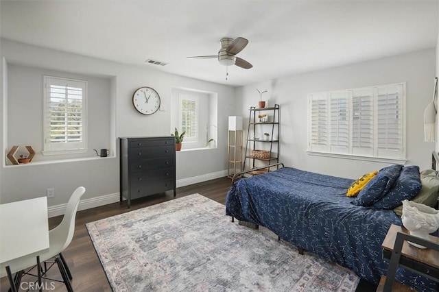 bedroom featuring baseboards, ceiling fan, wood finished floors, and visible vents