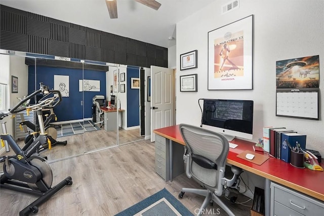 office featuring visible vents, light wood-style flooring, and ceiling fan