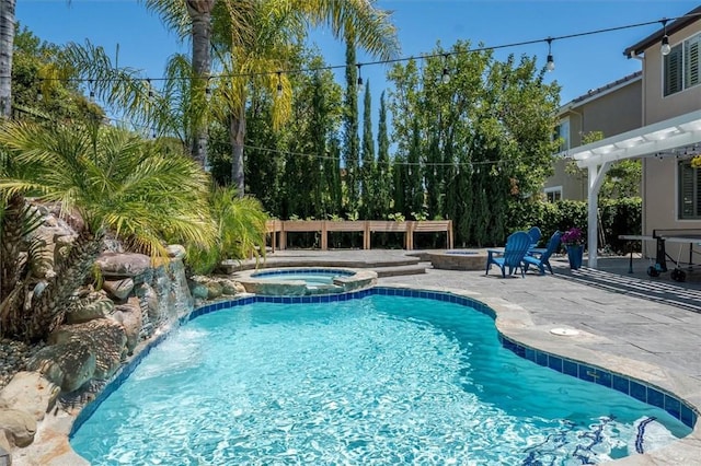 view of pool with a pergola, a pool with connected hot tub, and a patio area