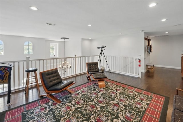 sitting room featuring recessed lighting, visible vents, wood finished floors, and an upstairs landing