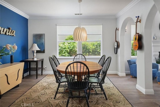 dining space with baseboards, plenty of natural light, and ornamental molding