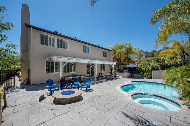 view of swimming pool with fence, a pergola, a fire pit, and a patio