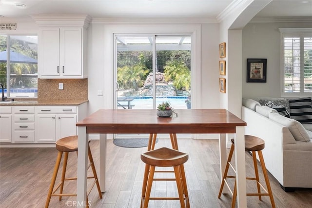 interior space with ornamental molding and wood finished floors