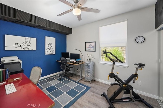 office area with baseboards, ceiling fan, and wood finished floors