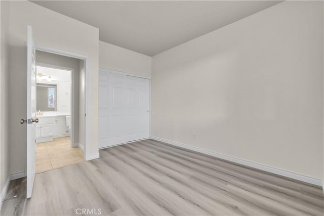 9058 Chimney Rock Ave, Hesperia, CA 92344 - unfurnished bedroom with light wood finished floors, baseboards, and a closet