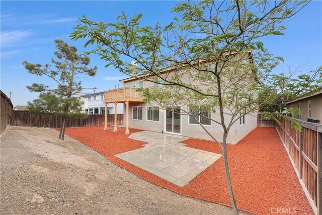 9058 Chimney Rock Ave, Hesperia, CA 92344 - back of house with a fenced backyard, a patio area, and stucco siding