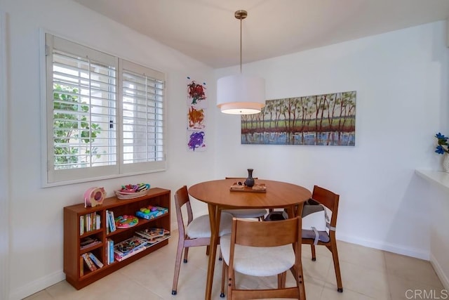 dining space with plenty of natural light, baseboards, and tile patterned flooring