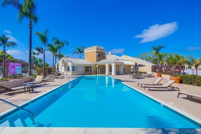 pool with fence and a patio
