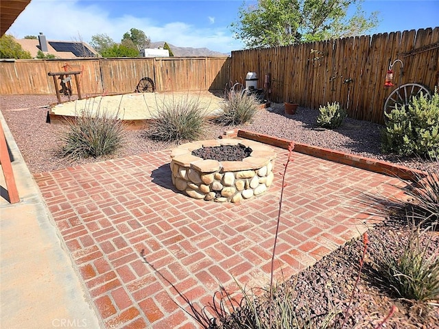 view of patio with a fire pit and a fenced backyard