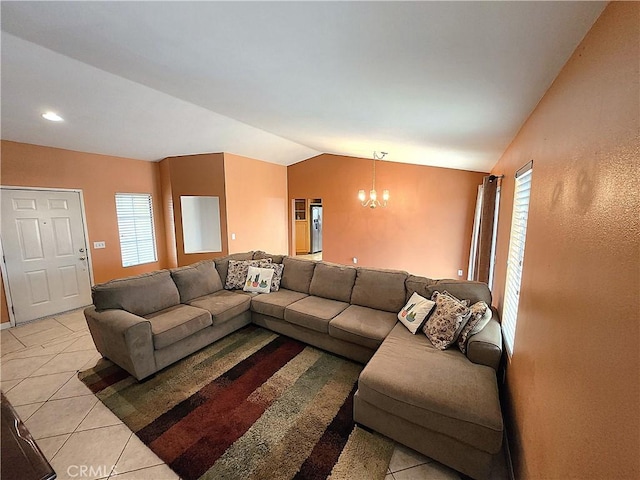 living room with lofted ceiling, light tile patterned flooring, and a notable chandelier