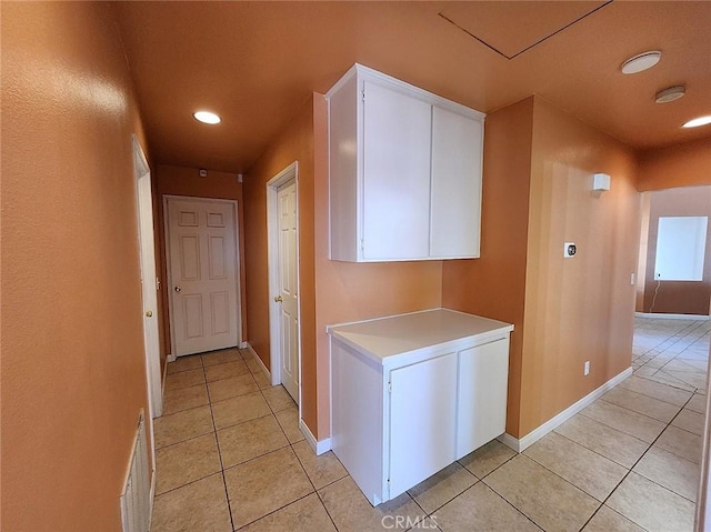 hall featuring recessed lighting, baseboards, light tile patterned floors, and visible vents