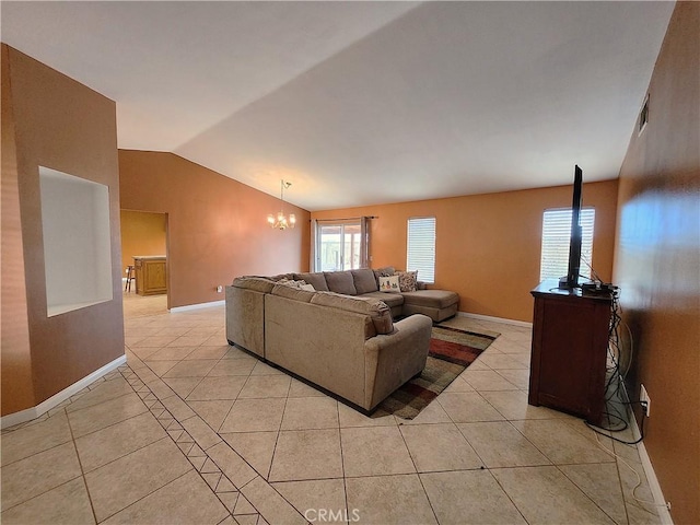 living room featuring vaulted ceiling, an inviting chandelier, a wealth of natural light, and light tile patterned floors
