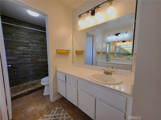full bath featuring toilet, tiled shower, tile patterned floors, and vanity