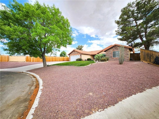ranch-style home featuring fence, a garage, stucco siding, and driveway