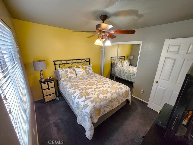 bedroom featuring a closet, baseboards, a ceiling fan, and carpet floors