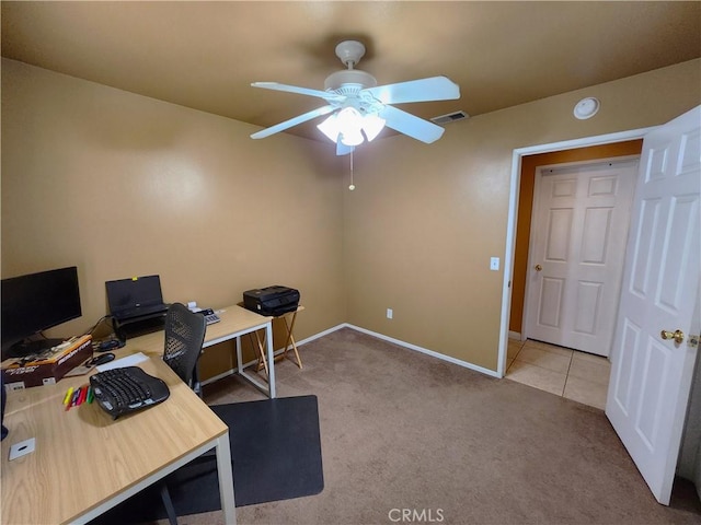 carpeted home office featuring visible vents, baseboards, and a ceiling fan