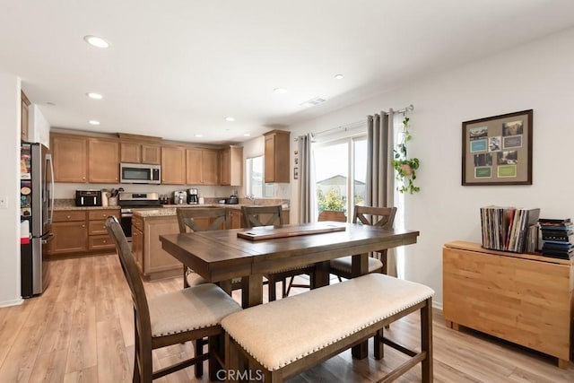 24060 Raptor Way, Lake Elsinore, CA 92532 - dining area with light wood-style floors, recessed lighting, and baseboards