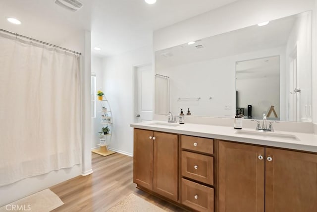 24060 Raptor Way, Lake Elsinore, CA 92532 - full bathroom featuring double vanity, wood finished floors, and recessed lighting