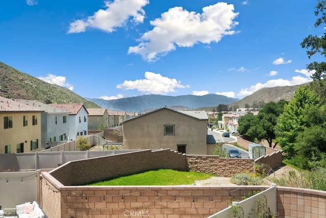 24060 Raptor Way, Lake Elsinore, CA 92532 - view of home's exterior with a mountain view, a residential view, a fenced backyard, and stucco siding