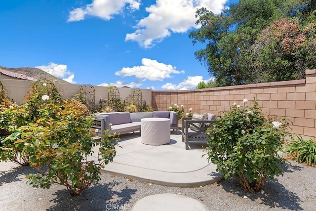 24060 Raptor Way, Lake Elsinore, CA 92532 - fenced backyard with an outdoor hangout area and a patio