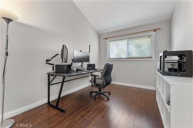 home office featuring baseboards, lofted ceiling, and wood finished floors