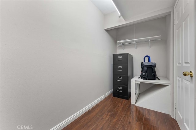 interior space with baseboards and dark wood-style floors