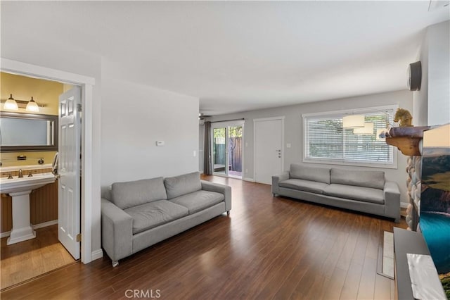 living area featuring a ceiling fan and wood finished floors