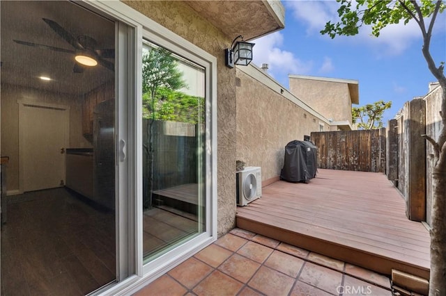 deck with ac unit, fence, and grilling area
