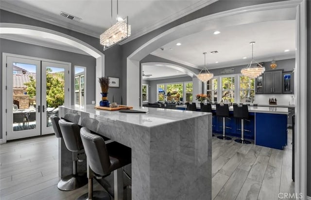 bar with french doors, recessed lighting, arched walkways, and visible vents