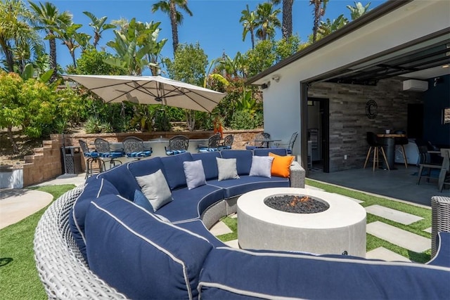view of patio / terrace featuring an outdoor living space with a fire pit